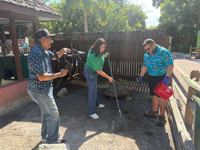 Grapevine Videographer, Felix, Filming Nichole and Shane cleaning out the tortoise enclosure at Sarasota Jungle Gardens.